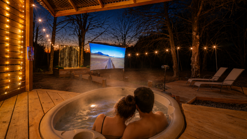 Couple relaxing in a private hot tub during a romantic glamping getaway near Dallas at dusk.